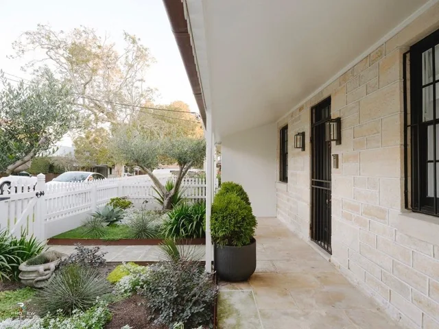 Heritage sandstone exterior with white picket fence, Queens Park