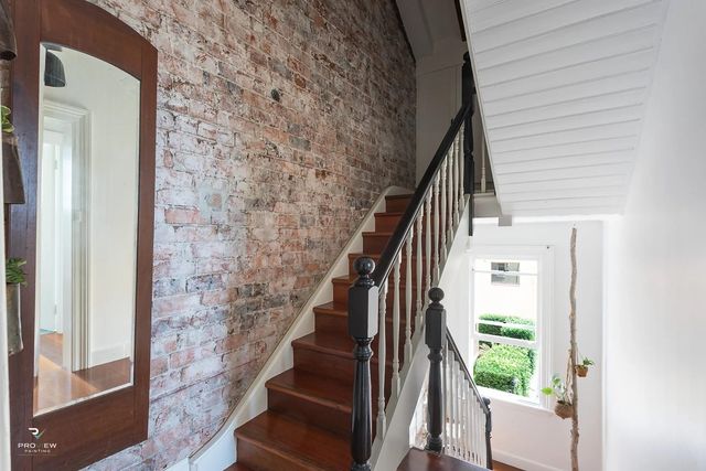 Victorian terrace staircase with exposed sandstock brick wall, Potts Point