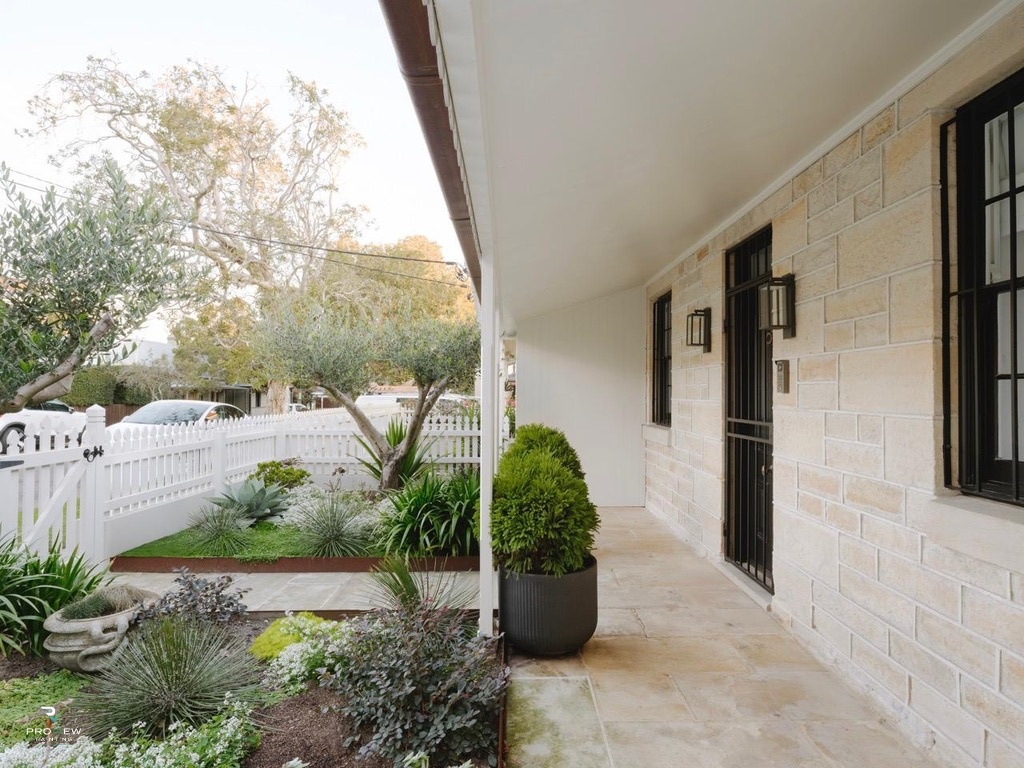 Heritage sandstone exterior with white picket fence