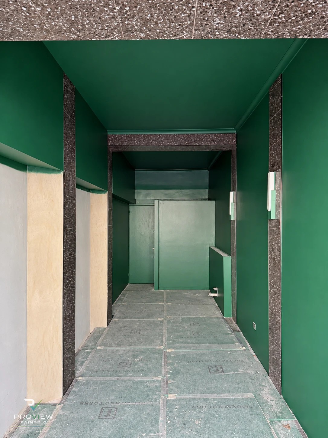 JA Hair Salon Potts Point during the fit-out — emerald green walls and ceilings painted, floor protection still down
