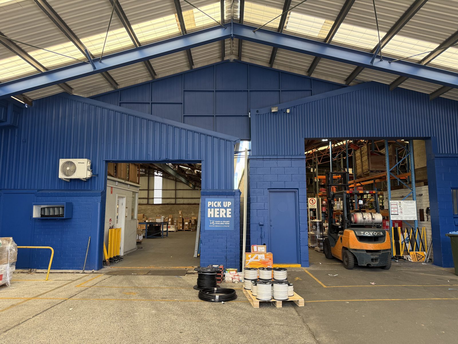 After — the same warehouse bays in L&H blue