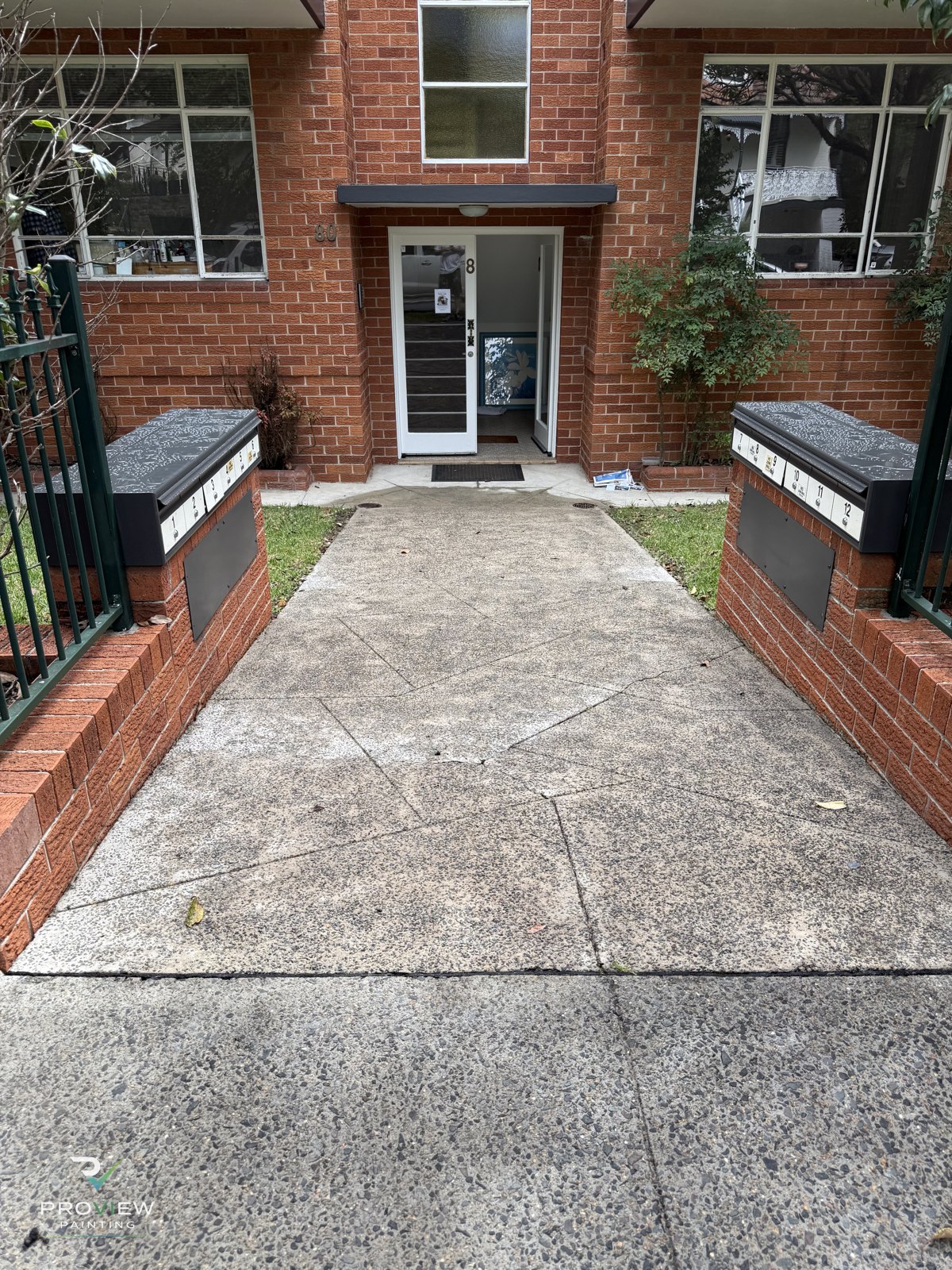 Repainted entry and front path of the Mosman strata block
