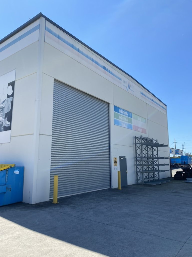 Before — the warehouse corner in its old white cladding